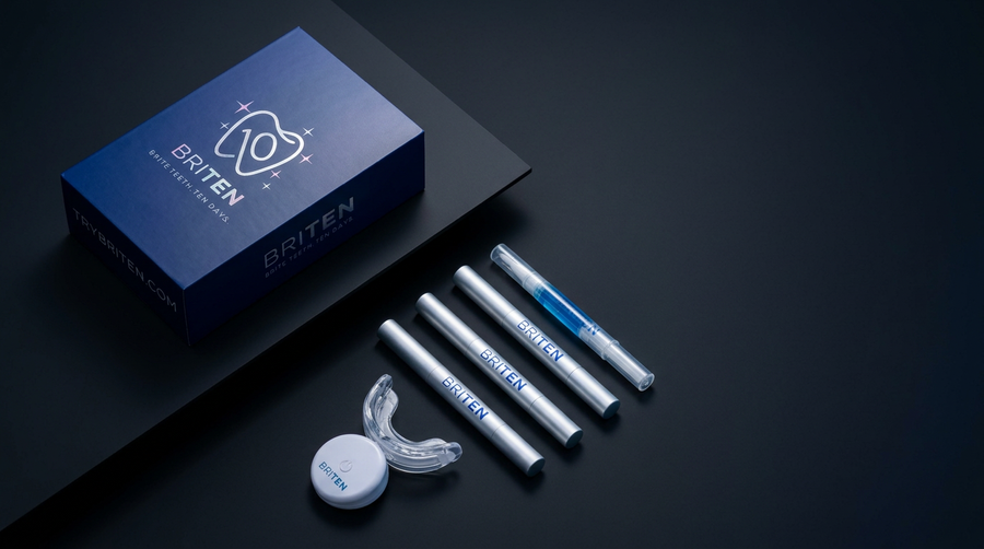 BRITEN whitening kit unboxed with glowing LED mouthpiece, power pod, and gel pens